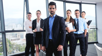 group of the formal co-workers are standing at the front of the camera