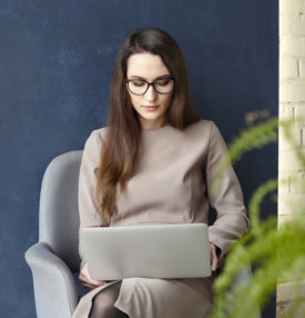 woman is doing a her work at the laptop