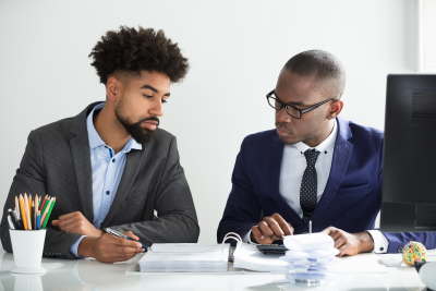 Business colleagues calculating tax